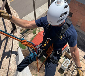 Greeley firefighter performing high angle training