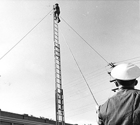 Old photo of Greeley firefighters engaged in a training exercise